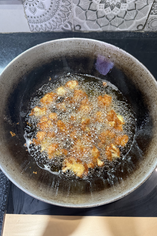 Marinated cauliflower florets fried in hot oil