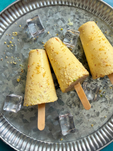 homemade malai kulfi garnished with finely powdered nuts served on a plate